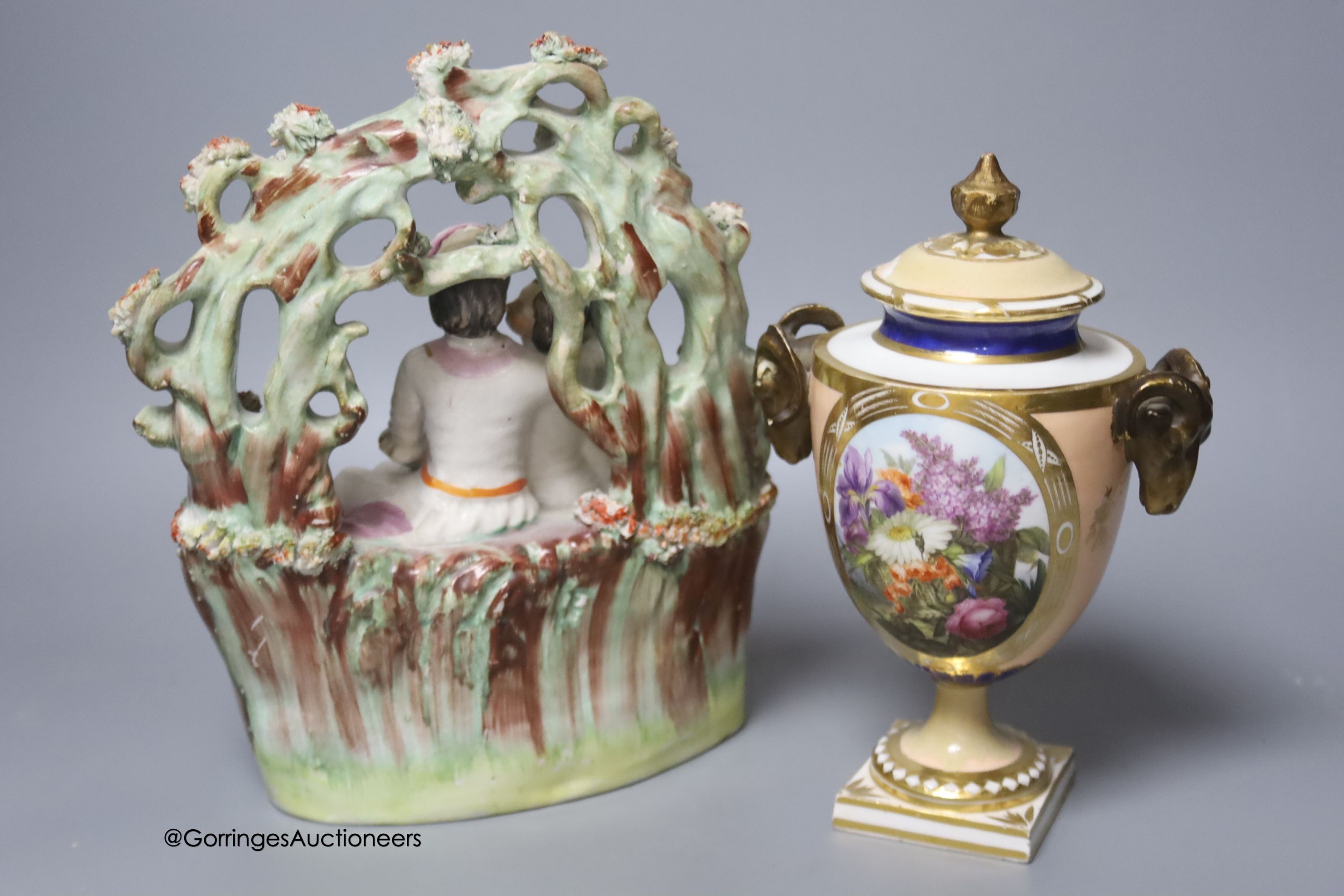 An early 19th century Derby vase, associated cover, a Staffordshire seated gentleman and an arbour group, tallest 25cm